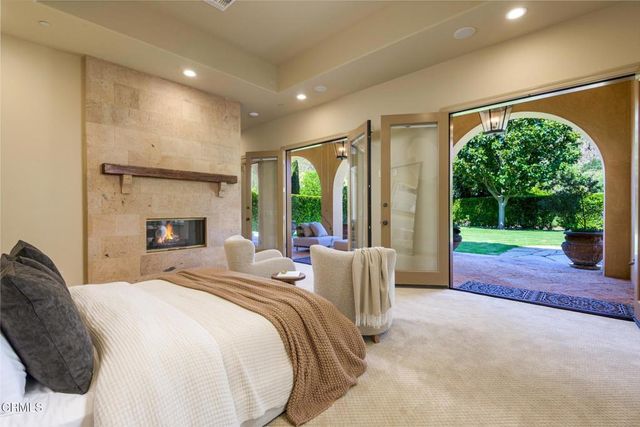 a bedroom with two beds and a large window