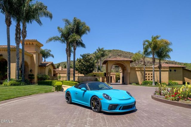 a view of swimming pool with outdoor seating and a garden