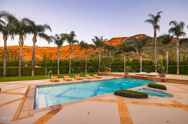 a view of a house with a backyard and a patio