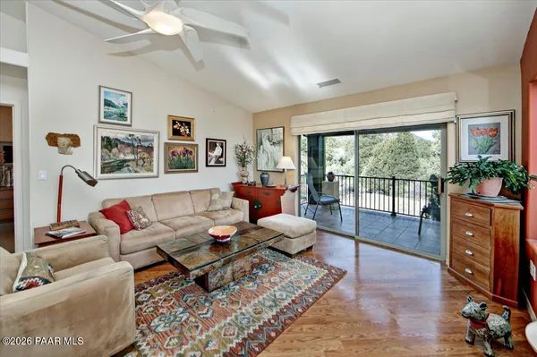 a living room with furniture a fireplace and a large window