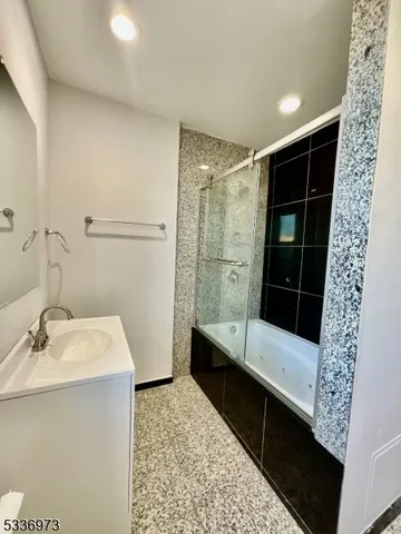 a bathroom with a bathtub and a shower