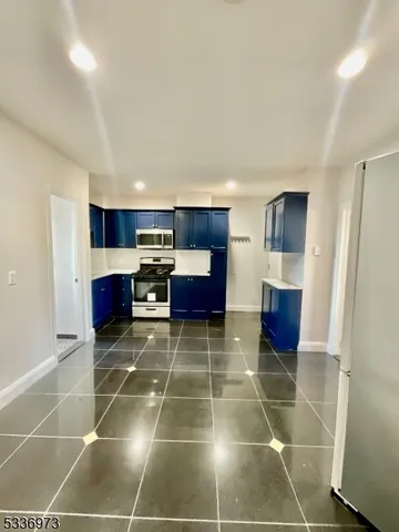 a room with gym equipment and a view of living room