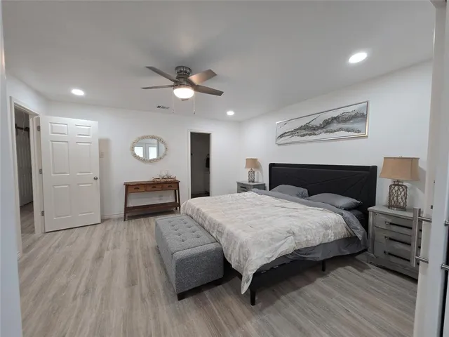 a bedroom with a bed and a mirror