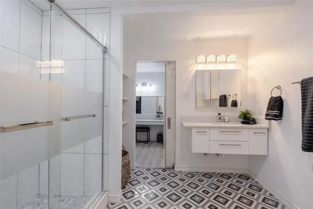 a room with a walk in closet and a mirror