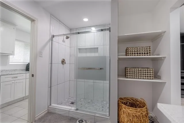 a bathroom with a shower and a sink