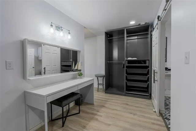 a view of hallway with wooden floor