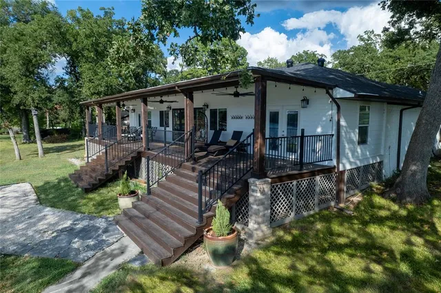 a view of a house with a yard deck and a slide