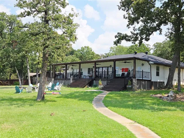 a front view of a house with a yard table and chairs