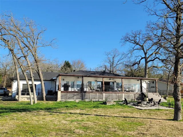 an aerial view of a house with swimming pool having outdoor seating
