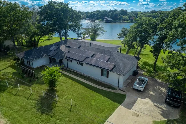 an aerial view of a house with garden space and street view