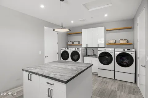 a bedroom with granite countertop a bed and a sink