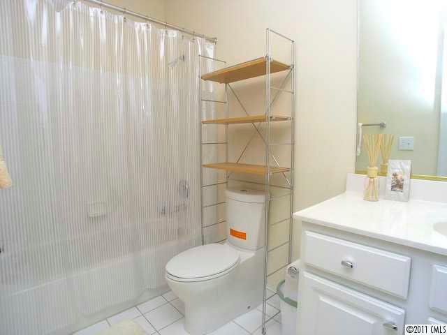 5617 Fairview Road, Unit 12 Charlotte, NC 28209 - Photo 11 of 14 a bathroom with a sink a toilet and shower