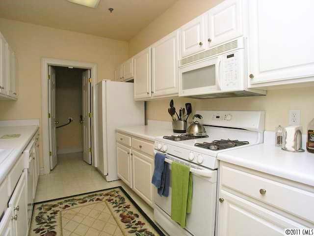 5617 Fairview Road, Unit 12 Charlotte, NC 28209 - Photo 7 of 14 a kitchen with a stove a sink and a refrigerator