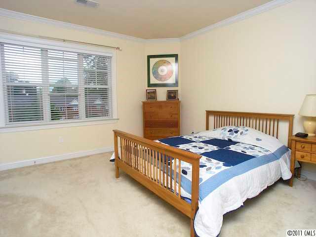 5617 Fairview Road, Unit 12 Charlotte, NC 28209 - Photo 9 of 14 a bedroom with bed and a window