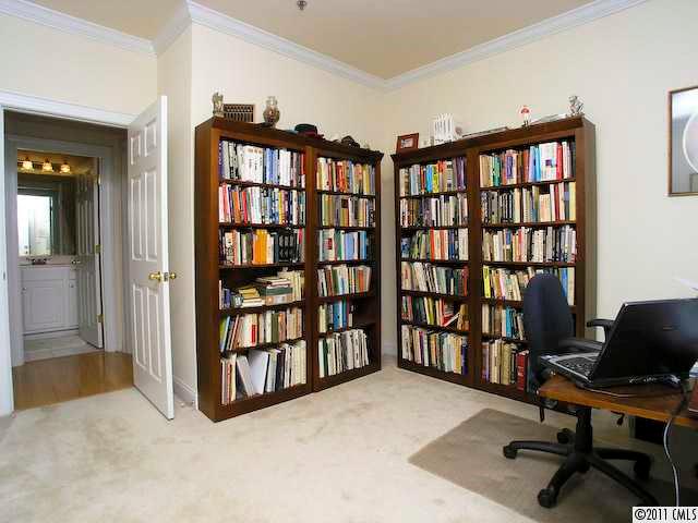 5617 Fairview Road, Unit 12 Charlotte, NC 28209 - Photo 10 of 14 a view of a workspace with bookshelf and a window