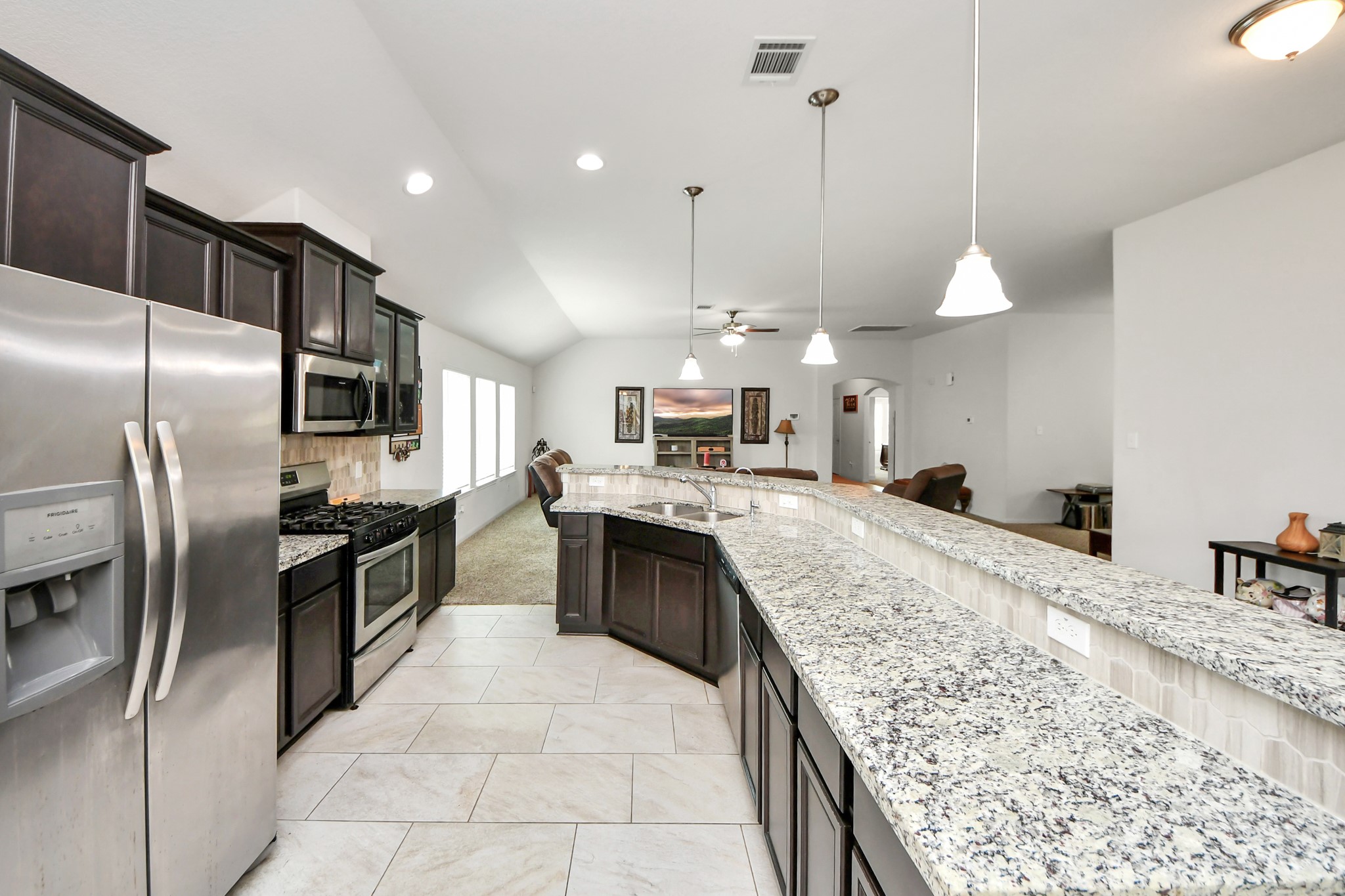 6226 Mason Way Rosenberg, TX 77471 - Photo 3 of 30 a large kitchen with stainless steel appliances kitchen island granite countertop a large counter top cabinets and stainless steel appliances