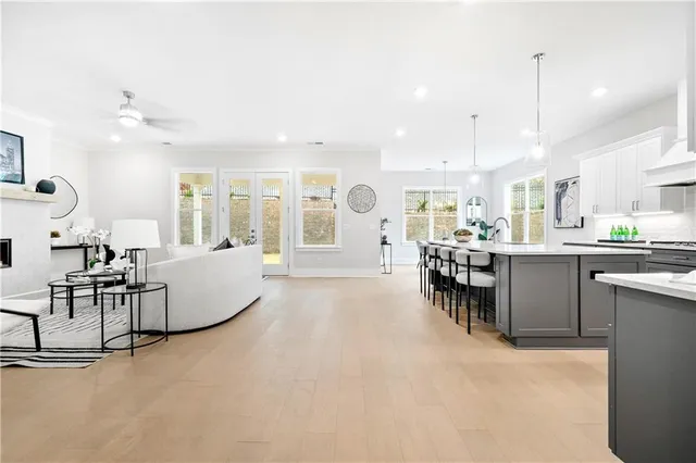 a kitchen with kitchen island granite countertop a sink a counter space and stainless steel appliances