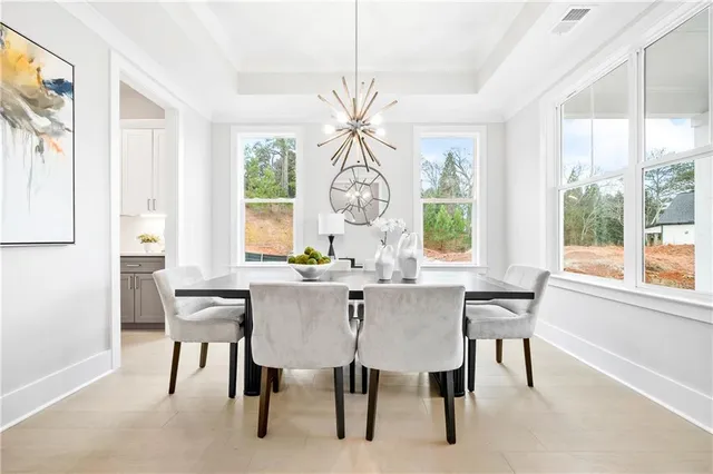 a living room with furniture a table and a large window