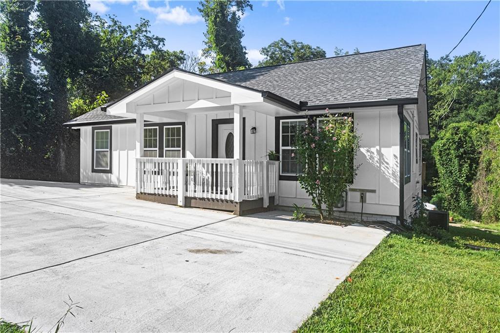 5626 Austell Powder Springs Road Southwest Austell, GA 30106 - Photo 1 of 36 a front view of a house with a garden and plants