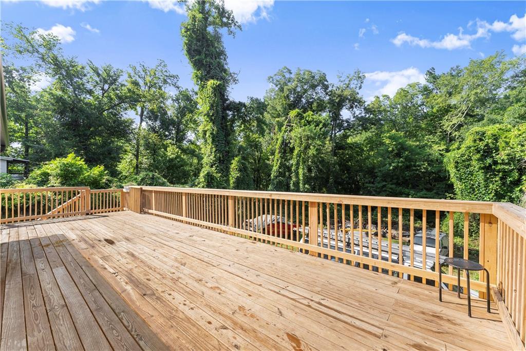 5626 Austell Powder Springs Road Southwest Austell, GA 30106 - Photo 11 of 36 a balcony with wooden floor and yard in the back