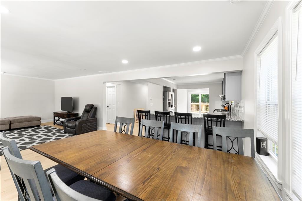 5626 Austell Powder Springs Road Southwest Austell, GA 30106 - Photo 18 of 36 a view of a dining room with furniture and wooden floor