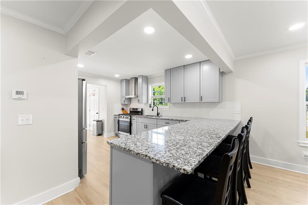 5626 Austell Powder Springs Road Southwest Austell, GA 30106 - Photo 20 of 36 a kitchen with granite countertop kitchen island sink table and chairs