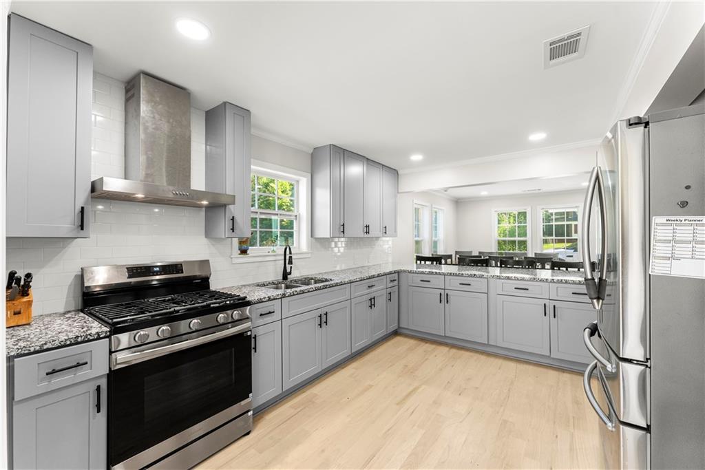 5626 Austell Powder Springs Road Southwest Austell, GA 30106 - Photo 2 of 36 a kitchen with granite countertop stainless steel appliances sink and cabinets