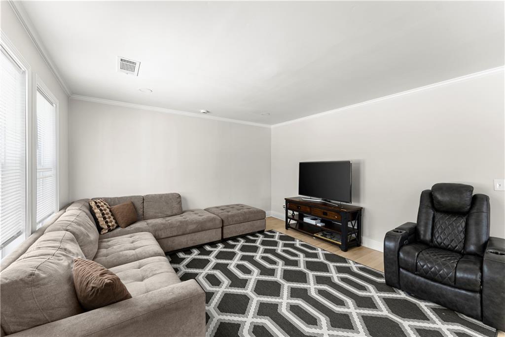5626 Austell Powder Springs Road Southwest Austell, GA 30106 - Photo 23 of 36 a living room with furniture and a flat screen tv