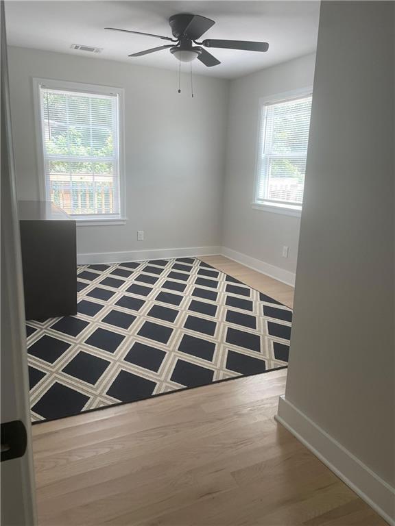 5626 Austell Powder Springs Road Southwest Austell, GA 30106 - Photo 30 of 36 a view of an empty room with a window and wooden floor