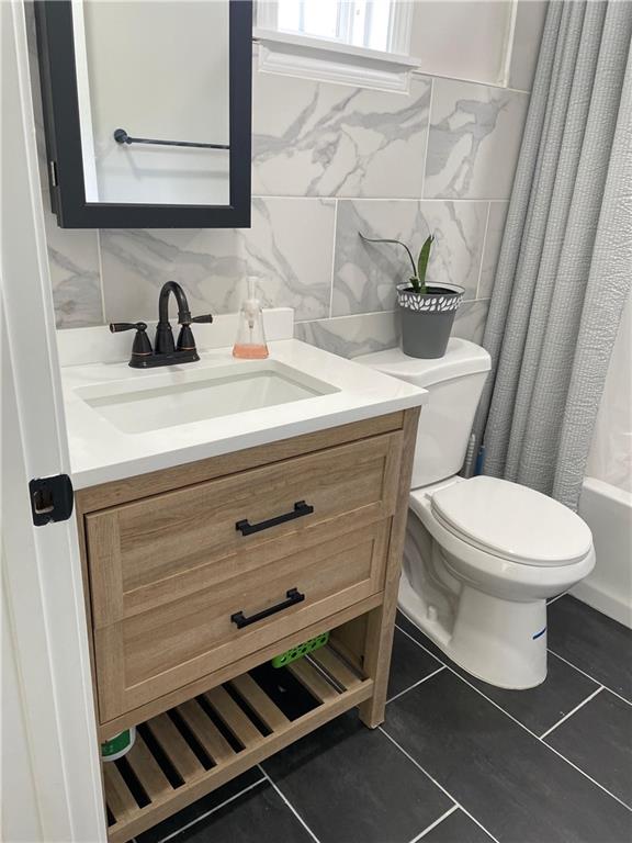 5626 Austell Powder Springs Road Southwest Austell, GA 30106 - Photo 32 of 36 a bathroom with a toilet a sink and a mirror