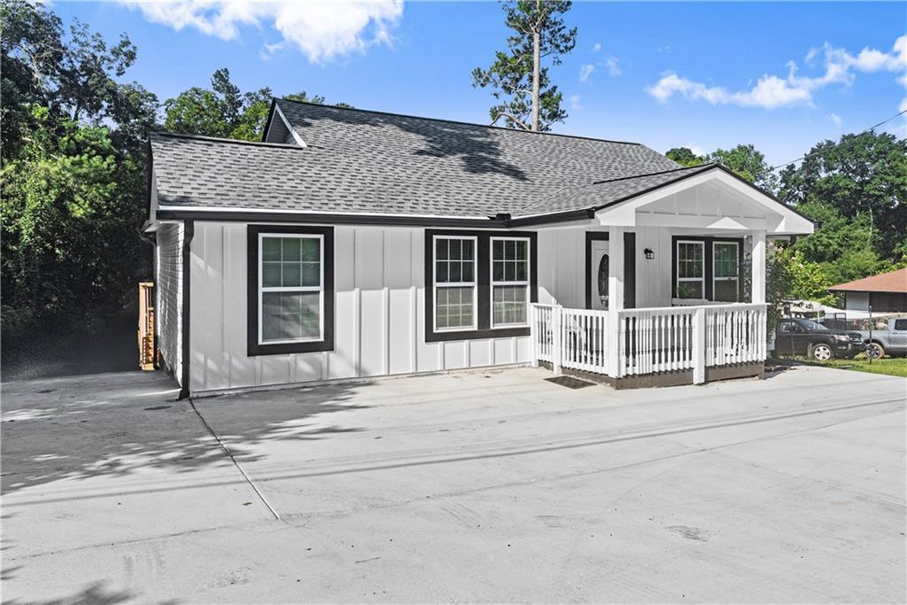5626 Austell Powder Springs Road Southwest Austell, GA 30106 - Photo 7 of 36 a front view of a house with a garden