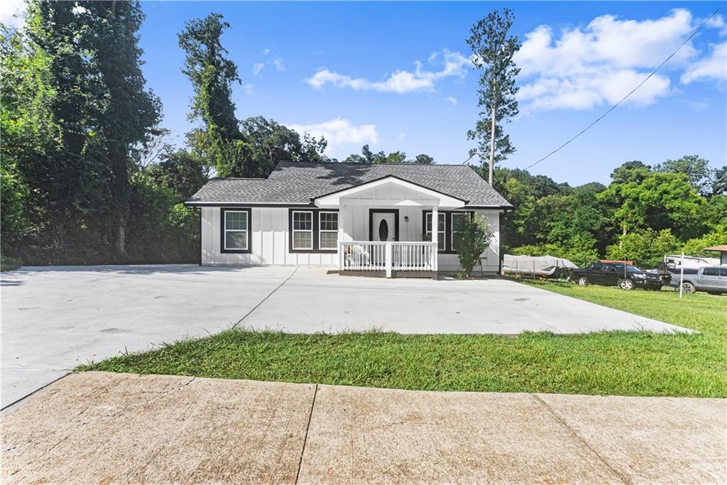 5626 Austell Powder Springs Road Southwest Austell, GA 30106 - Photo 9 of 36 a front view of a house with a yard and potted plants