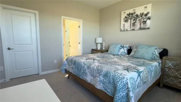 a bedroom with a bed and a wall painting