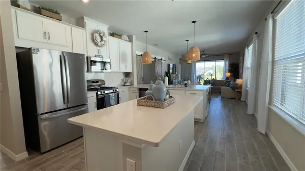a kitchen with refrigerator and windows