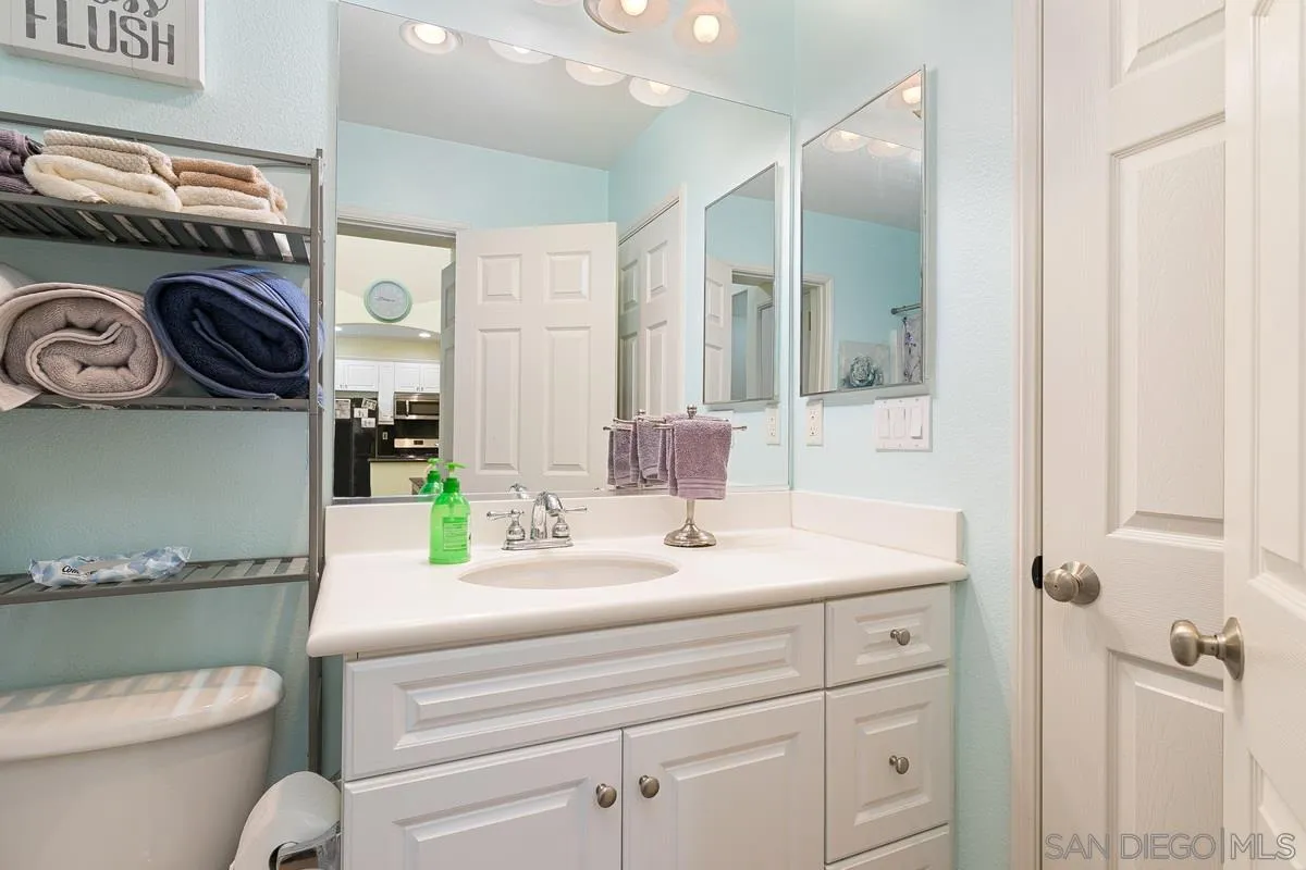4103 Karst Road Carlsbad, CA 92010 - Photo 11 of 16 a bathroom with a sink a toilet and a mirror