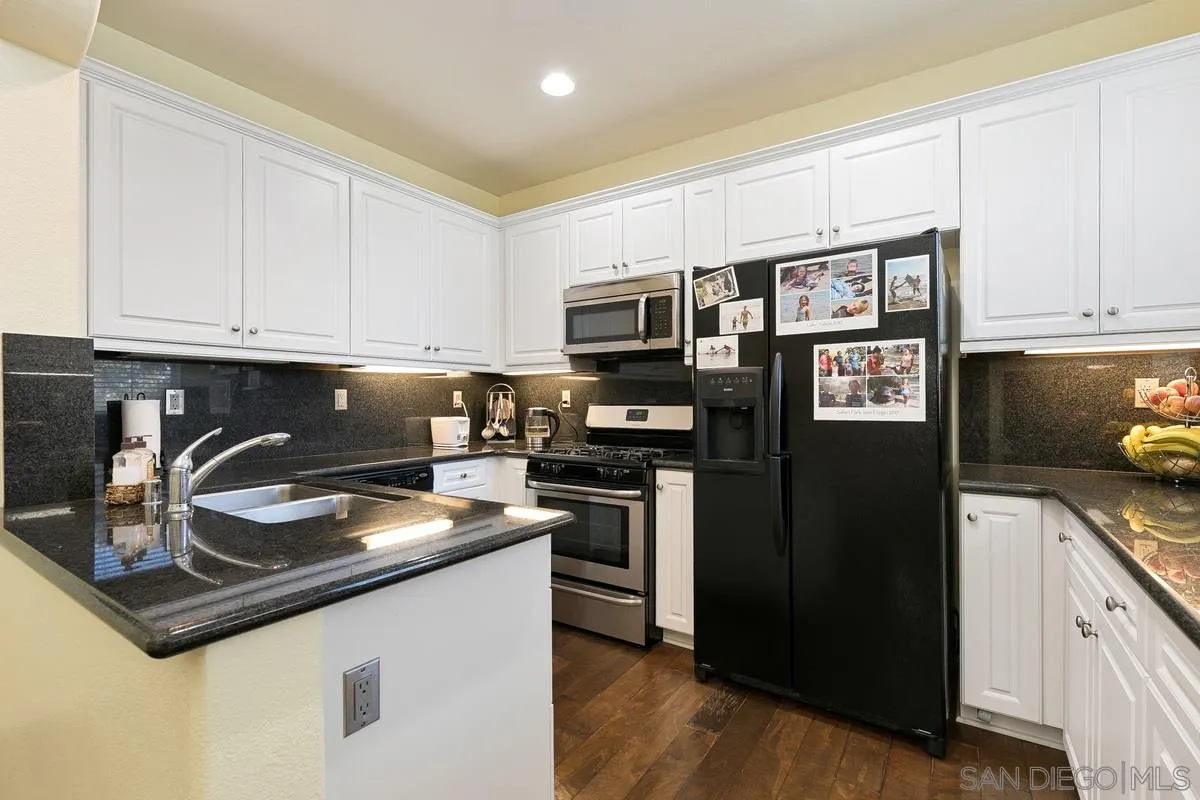 4103 Karst Road Carlsbad, CA 92010 - Photo 4 of 16 a kitchen with stainless steel appliances granite countertop a refrigerator a stove a sink and a microwave