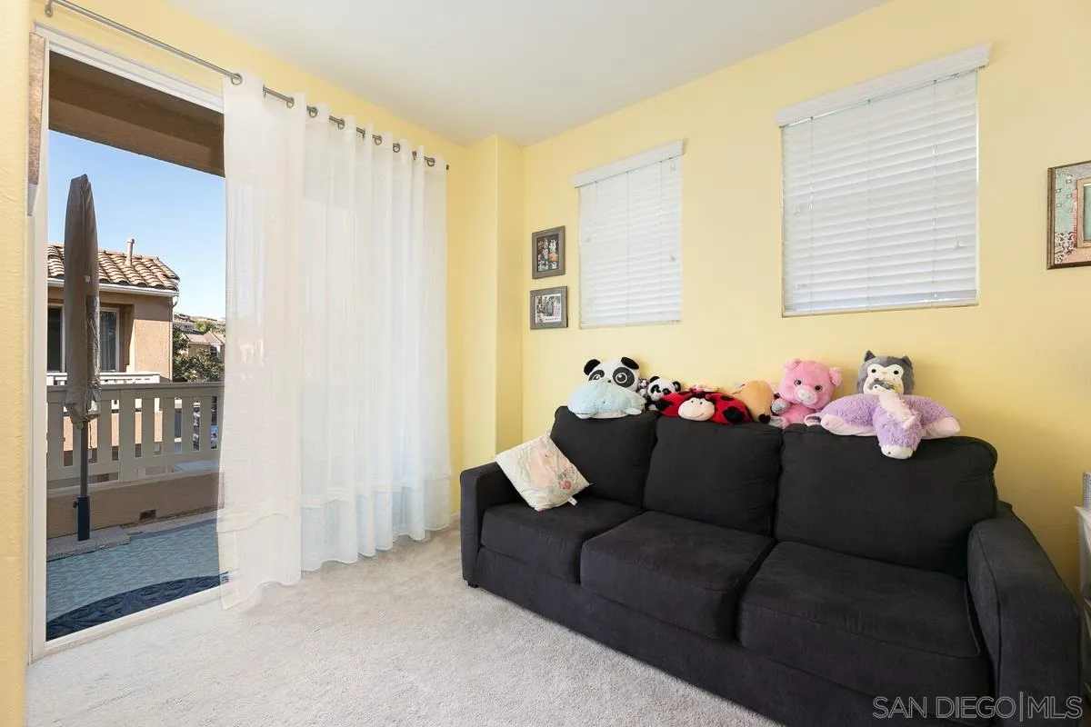 4103 Karst Road Carlsbad, CA 92010 - Photo 6 of 16 a living room with furniture and a chandelier