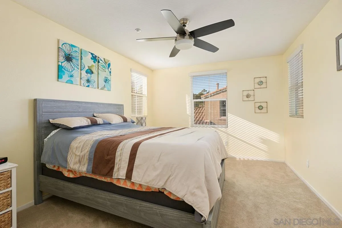 4103 Karst Road Carlsbad, CA 92010 - Photo 9 of 16 a bedroom with a large bed and a chandelier