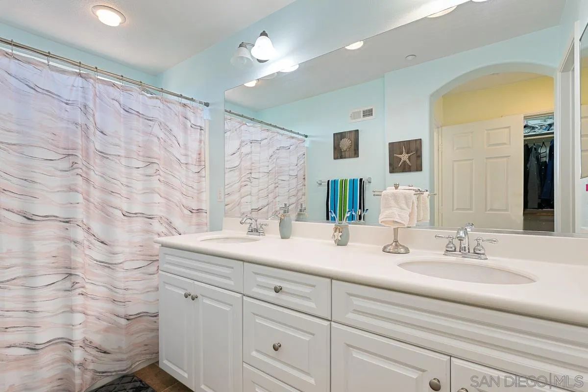 4103 Karst Road Carlsbad, CA 92010 - Photo 10 of 16 a bathroom with a sink double vanity and a mirror