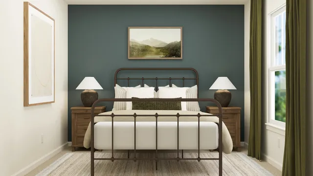 a bed sitting in a bedroom next to a window