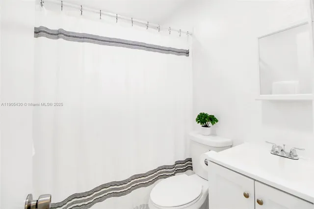 a bathroom with a sink toilet and a mirror