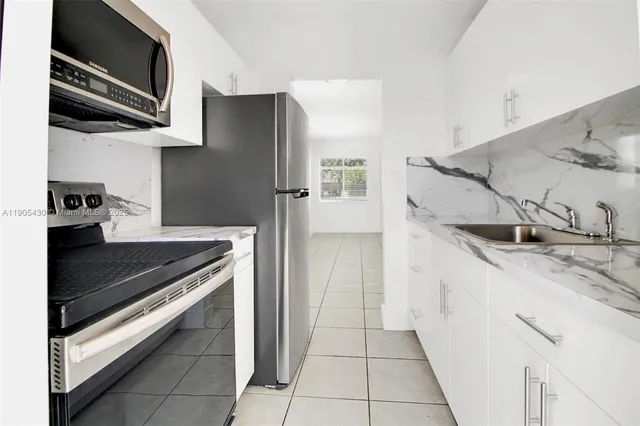 a kitchen with a refrigerator and a stove
