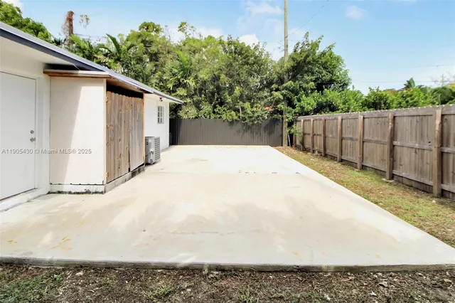 a white house with tree in the background