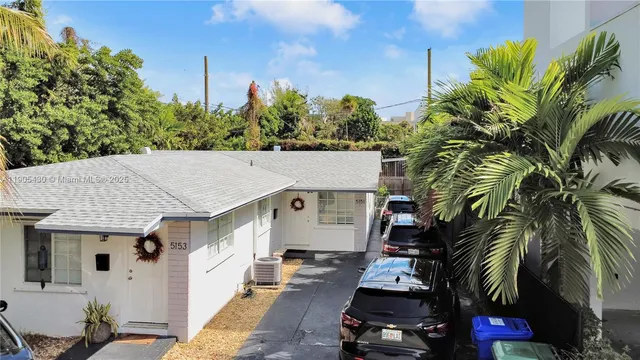 a aerial view of a house with a yard and potted plants