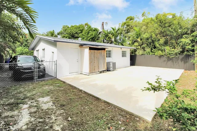 a house with trees in the background