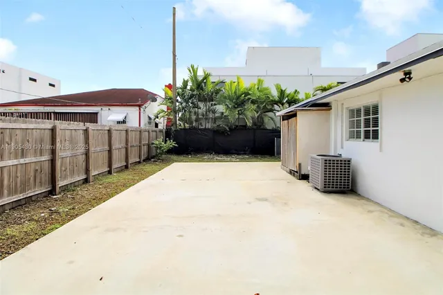 a view of a house with potted plants and a garage