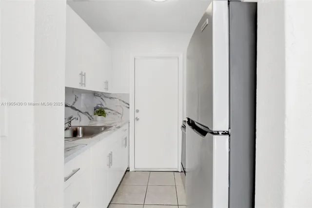 a kitchen with a sink and refrigerator