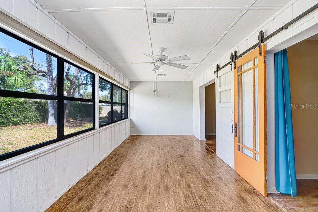 2025 Sylvester Road, Unit C2 Lakeland, FL 33803 - Photo 4 of 28 a view of a big room with wooden floor fan and windows