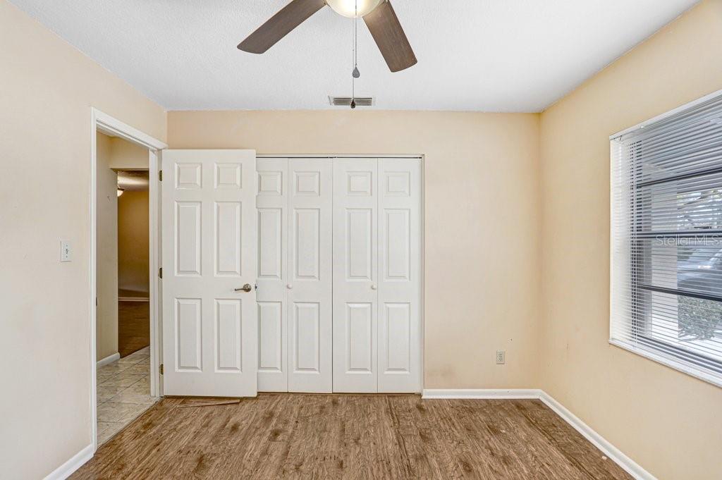 2025 Sylvester Road, Unit C2 Lakeland, FL 33803 - Photo 8 of 28 an empty room with wooden floor cabinet and windows