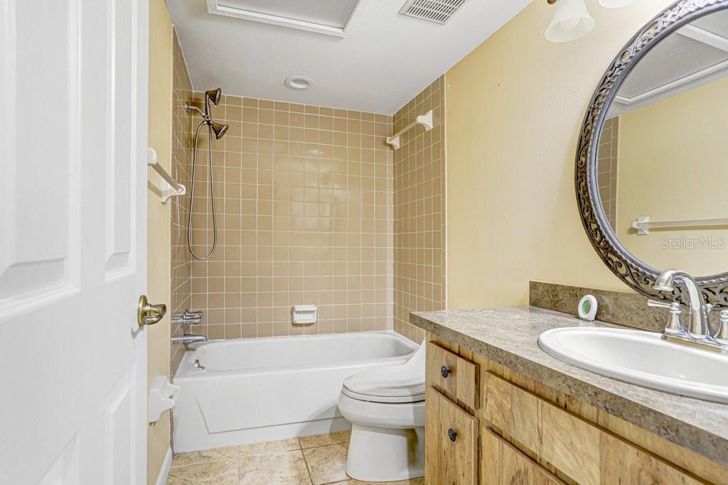 2025 Sylvester Road, Unit C2 Lakeland, FL 33803 - Photo 10 of 28 a bathroom with a granite countertop sink toilet and shower